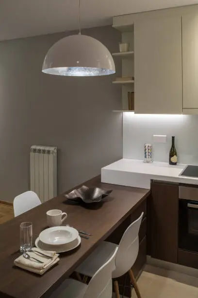 Small kitchen with multifunctional island and LED lighting.